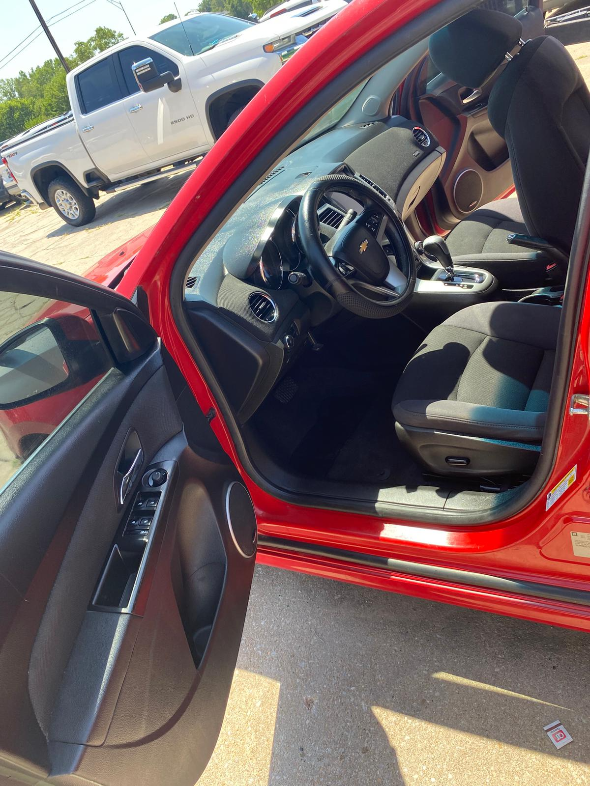 Red Chevy interior - driver side full view with white truck background